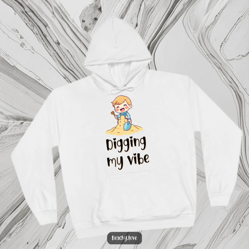 Funny hoodie featuring a tiny character gleefully building a sandcastle with a tiny shovel, perfect for cozy beach days and playful comfort.