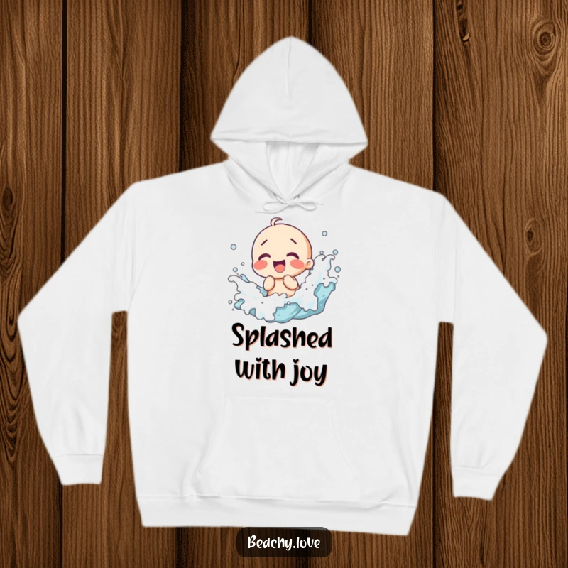 Funny hoodie showing a kawaii character giggling as waves splash around them, perfect for staying warm with a cheerful beach vibe.