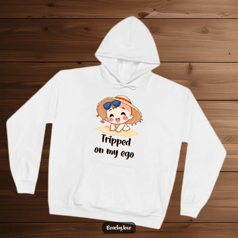 Funny hoodie showcasing a happy character wearing a sun hat, comically tripping on the beach sand, comfortable and humorous apparel.
